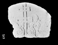 Stone with relief image of six-pointed cross with its base sprouting in the shape of scrolls